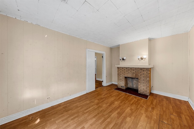 526 N 16th St, Waco, TX 76707 - unfurnished living room featuring wood finished floors and a brick fireplace