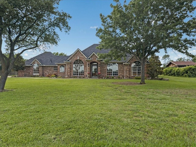 10353 W Dublin Dr, Forney, TX 75126 - view of front of property featuring a front yard, brick siding, and a shingled roof