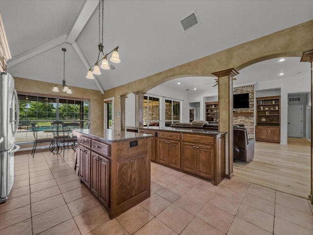 10353 W Dublin Dr, Forney, TX 75126 - kitchen featuring freestanding refrigerator, decorative columns, a kitchen island, open floor plan, and recessed lighting