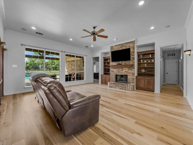 10353 W Dublin Dr, Forney, TX 75126 - living area featuring ceiling fan, recessed lighting, ornamental molding, a brick fireplace, and light wood-type flooring