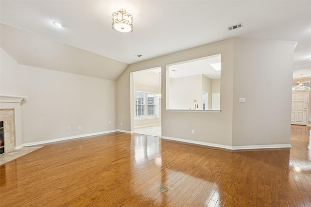 4069 White Porch Rd, Plano, TX 75024 - unfurnished living room with a fireplace, wood-type flooring, and vaulted ceiling
