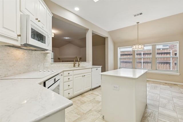 4069 White Porch Rd, Plano, TX 75024 - kitchen featuring white appliances, light marble finish flooring, decorative backsplash, a kitchen island, and vaulted ceiling