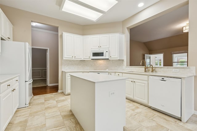 4069 White Porch Rd, Plano, TX 75024 - kitchen featuring white appliances, tasteful backsplash, white cabinetry, and a kitchen island