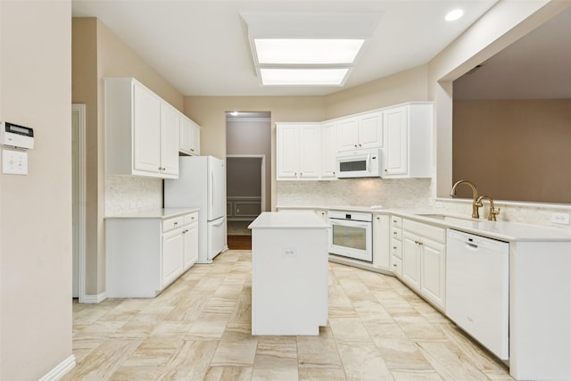 4069 White Porch Rd, Plano, TX 75024 - kitchen featuring white appliances, a center island, decorative backsplash, light countertops, and white cabinets