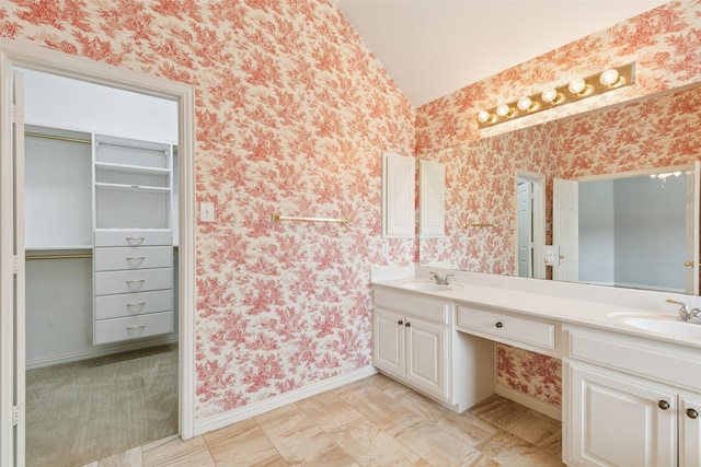 4069 White Porch Rd, Plano, TX 75024 - full bathroom with wallpapered walls, double vanity, and vaulted ceiling