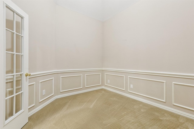 4069 White Porch Rd, Plano, TX 75024 - empty room featuring carpet flooring, a wainscoted wall, and a decorative wall