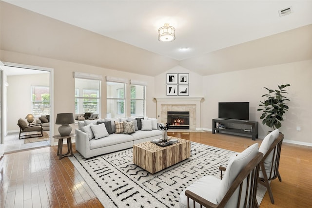 4069 White Porch Rd, Plano, TX 75024 - living area with light wood-type flooring, a tile fireplace, and lofted ceiling
