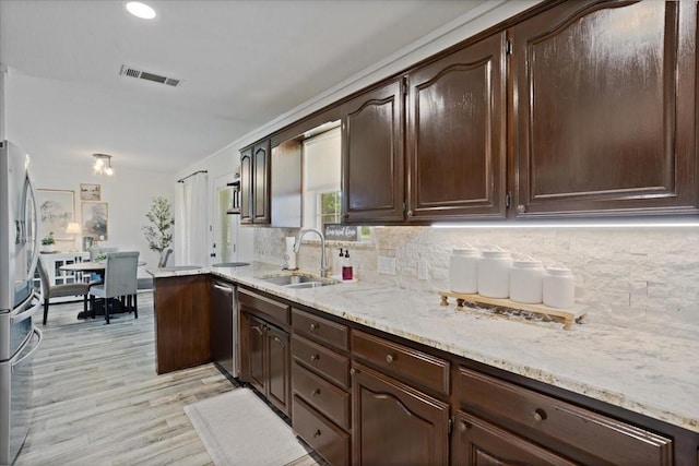 900 Amy Way, Bonham, TX 75418 - kitchen with stainless steel appliances, tasteful backsplash, dark brown cabinets, and recessed lighting