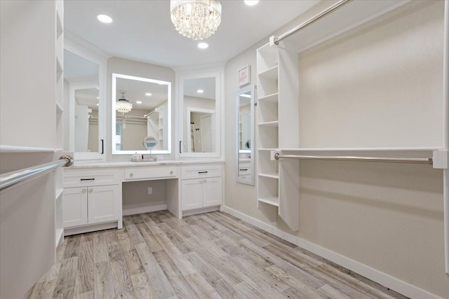 900 Amy Way, Bonham, TX 75418 - walk in closet with a chandelier and light wood-type flooring