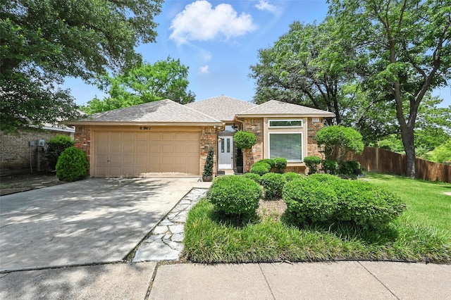 8311 Paxson Trl, Dallas, TX 75249 - view of front of home featuring an attached garage, driveway, and a shingled roof