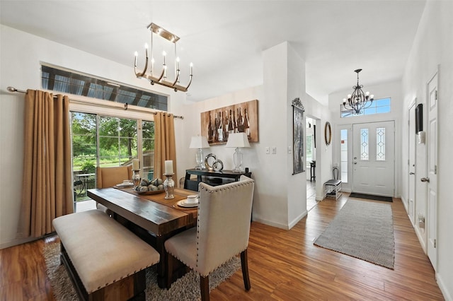 8311 Paxson Trl, Dallas, TX 75249 - dining area with a chandelier, healthy amount of natural light, and light wood-style floors