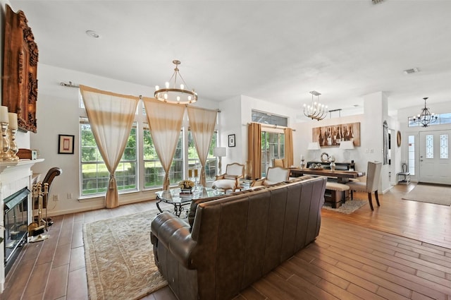 8311 Paxson Trl, Dallas, TX 75249 - living area featuring a chandelier, hardwood / wood-style floors, and a fireplace