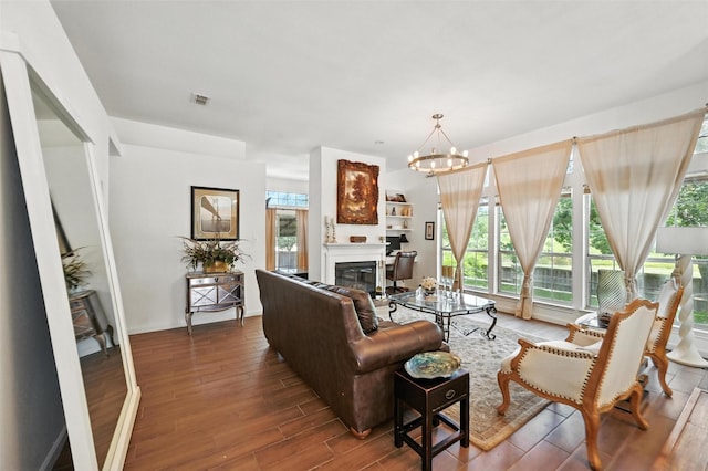 8311 Paxson Trl, Dallas, TX 75249 - living room featuring a glass covered fireplace, wood finished floors, and a chandelier