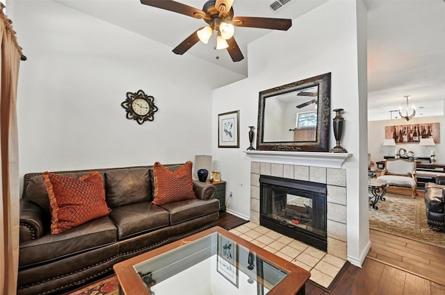 8311 Paxson Trl, Dallas, TX 75249 - living room with hardwood / wood-style flooring, a ceiling fan, a chandelier, and a tiled fireplace