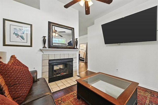 8311 Paxson Trl, Dallas, TX 75249 - living area featuring a ceiling fan, a tile fireplace, and wood finished floors