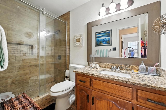 8311 Paxson Trl, Dallas, TX 75249 - full bath with vanity, a stall shower, and a textured wall