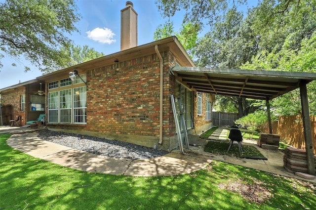 8311 Paxson Trl, Dallas, TX 75249 - view of property exterior featuring brick siding, a chimney, and a patio area
