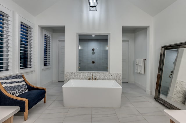 11405 Antler Ridge Way, Argyle, TX 76226 - bathroom featuring a stall shower, a soaking tub, marble look tile flooring, and high vaulted ceiling