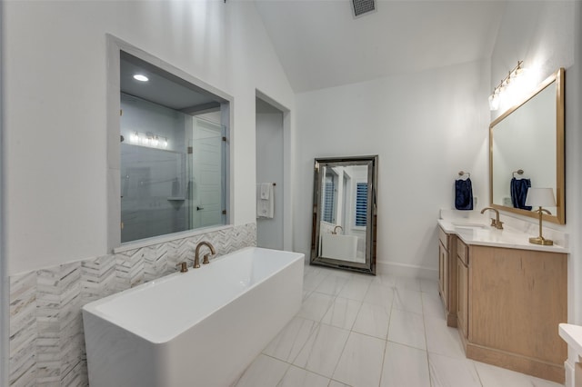 11405 Antler Ridge Way, Argyle, TX 76226 - bathroom featuring a soaking tub, vanity, a stall shower, vaulted ceiling, and tile patterned floors