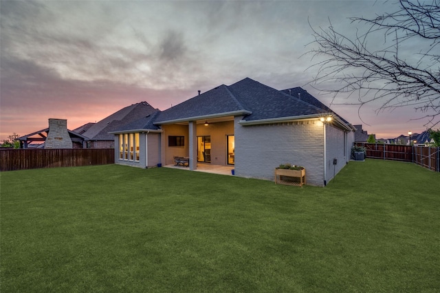 11405 Antler Ridge Way, Argyle, TX 76226 - back of property at dusk featuring a fenced backyard, brick siding, a patio area, a shingled roof, and a ceiling fan