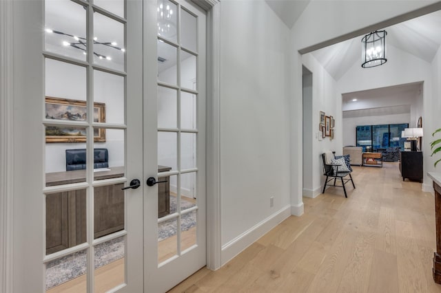 11405 Antler Ridge Way, Argyle, TX 76226 - corridor with vaulted ceiling, french doors, a chandelier, and wood finished floors