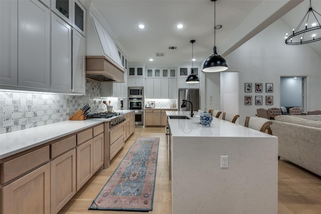 11405 Antler Ridge Way, Argyle, TX 76226 - kitchen with stainless steel appliances, premium range hood, open floor plan, tasteful backsplash, and a chandelier