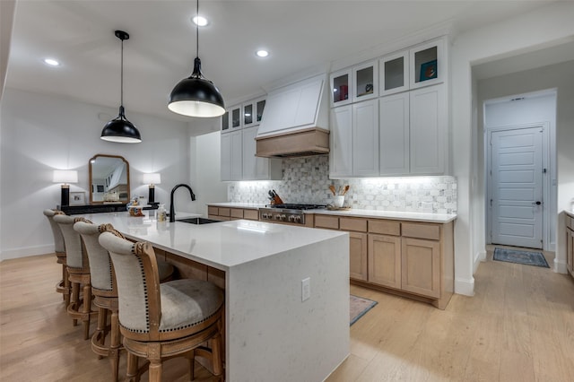11405 Antler Ridge Way, Argyle, TX 76226 - kitchen featuring custom range hood, light wood finished floors, backsplash, stainless steel gas cooktop, and recessed lighting