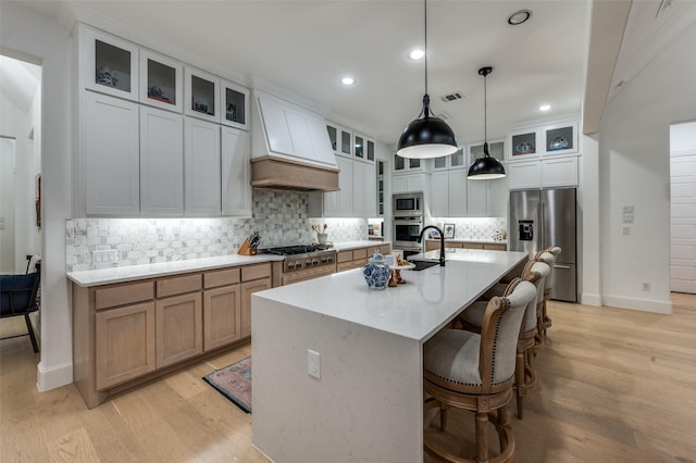 11405 Antler Ridge Way, Argyle, TX 76226 - kitchen featuring premium range hood, appliances with stainless steel finishes, a center island with sink, recessed lighting, and light wood finished floors