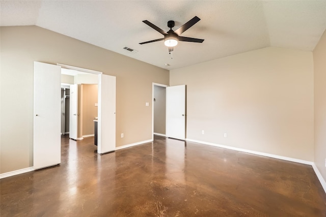 7921 Mourning Dove Dr, Arlington, TX 76002 - unfurnished bedroom featuring lofted ceiling, finished concrete floors, a ceiling fan, and a walk in closet