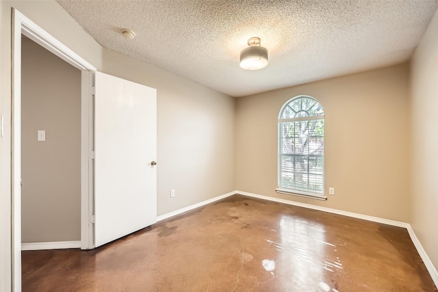 7921 Mourning Dove Dr, Arlington, TX 76002 - empty room featuring concrete flooring, a textured ceiling, and a smoke detector