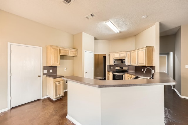 7921 Mourning Dove Dr, Arlington, TX 76002 - kitchen with appliances with stainless steel finishes, concrete floors, a peninsula, a textured ceiling, and light brown cabinets