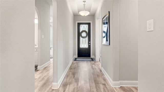 2809 Burgundy Trl, Rowlett, TX 75088 - doorway to outside featuring light wood-style floors, arched walkways, and a textured wall