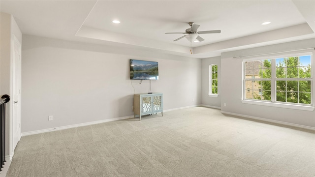 2809 Burgundy Trl, Rowlett, TX 75088 - unfurnished living room featuring carpet flooring, plenty of natural light, ceiling fan, recessed lighting, and a tray ceiling