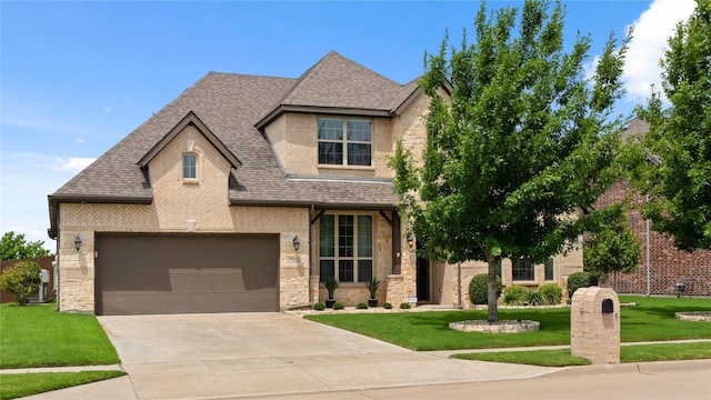 2809 Burgundy Trl, Rowlett, TX 75088 - view of front of house with a shingled roof, stone siding, a front yard, and concrete driveway