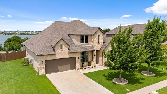 2809 Burgundy Trl, Rowlett, TX 75088 - view of front facade with stone siding, roof with shingles, and driveway