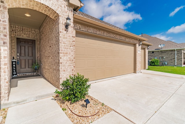 11401 Gale Ridge Ter, Fort Worth, TX 76052 - property entrance featuring brick siding, concrete driveway, and a garage