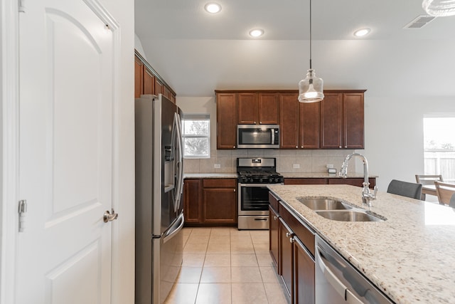 11401 Gale Ridge Ter, Fort Worth, TX 76052 - kitchen featuring stainless steel appliances, healthy amount of natural light, tasteful backsplash, light stone counters, and recessed lighting