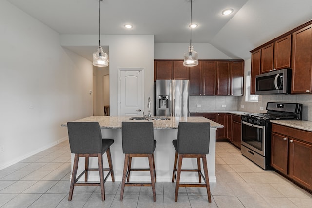 11401 Gale Ridge Ter, Fort Worth, TX 76052 - kitchen with appliances with stainless steel finishes, tasteful backsplash, light tile patterned flooring, vaulted ceiling, and a center island with sink