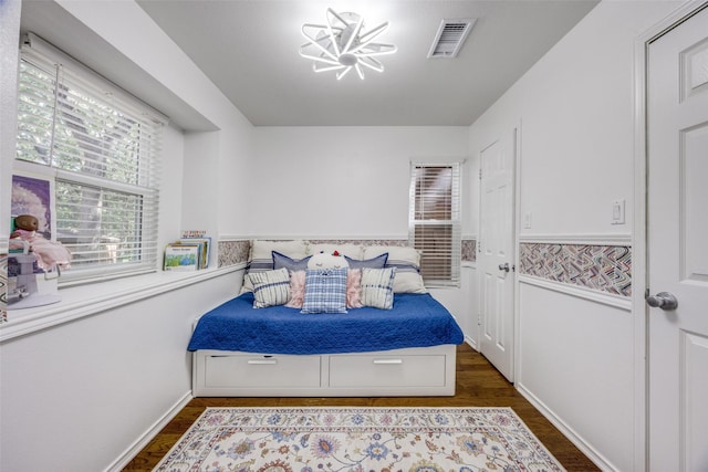 191 Black Forest Dr, Pottsboro, TX 75076 - bedroom featuring dark wood-type flooring and a chandelier
