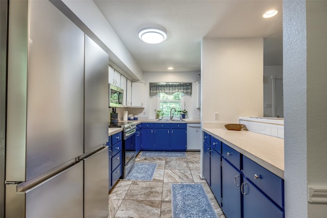 191 Black Forest Dr, Pottsboro, TX 75076 - kitchen featuring stainless steel appliances, blue cabinetry, light countertops, and recessed lighting