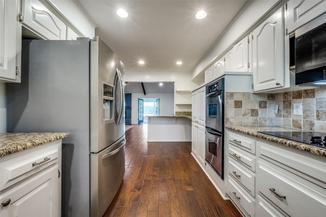 710 Northridge St, Denton, TX 76201 - kitchen with stainless steel appliances, dark wood-style flooring, light stone counters, and recessed lighting