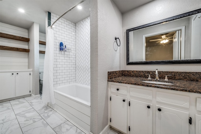 710 Northridge St, Denton, TX 76201 - bathroom featuring vanity, shower / bath combination with curtain, a textured wall, and marble look tile flooring