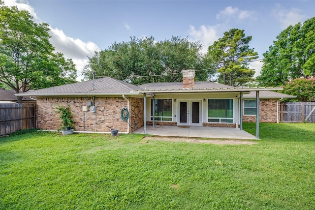 710 Northridge St, Denton, TX 76201 - rear view of house with french doors, a patio, a fenced backyard, brick siding, and a chimney