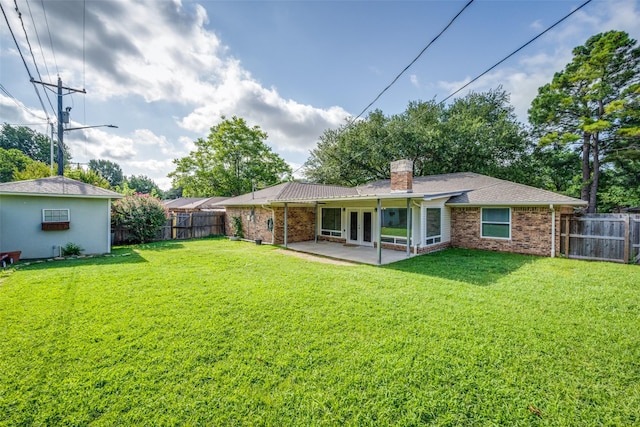 710 Northridge St, Denton, TX 76201 - rear view of property featuring french doors, brick siding, a fenced backyard, and a chimney
