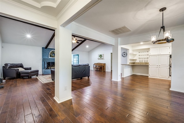 710 Northridge St, Denton, TX 76201 - living area with vaulted ceiling, dark wood-type flooring, a brick fireplace, ornamental molding, and a ceiling fan