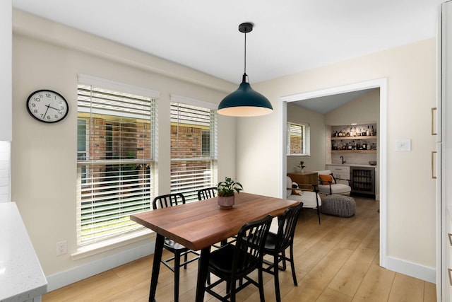6207 Crested Butte Dr, Dallas, TX 75252 - dining space featuring a bar, light wood finished floors, and wine cooler