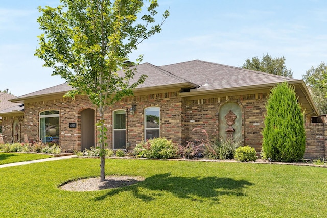 6207 Crested Butte Dr, Dallas, TX 75252 - view of front of home with a front yard, brick siding, and roof with shingles