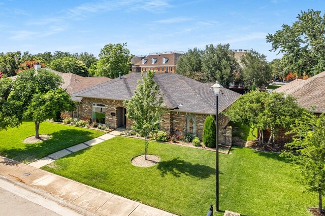 6207 Crested Butte Dr, Dallas, TX 75252 - view of front facade featuring a front yard, a shingled roof, and brick siding