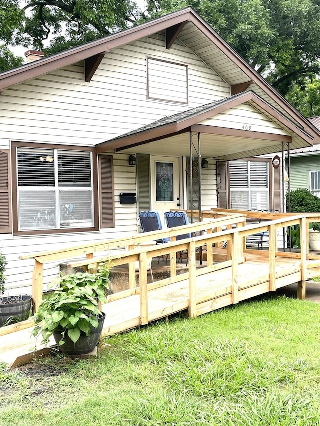 408 N Woods St, Sherman, TX 75092 - view of front of property featuring a chimney, a front yard, and a deck