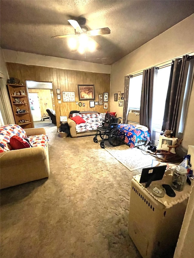 408 N Woods St, Sherman, TX 75092 - bedroom featuring carpet flooring, a textured ceiling, wooden walls, and ceiling fan